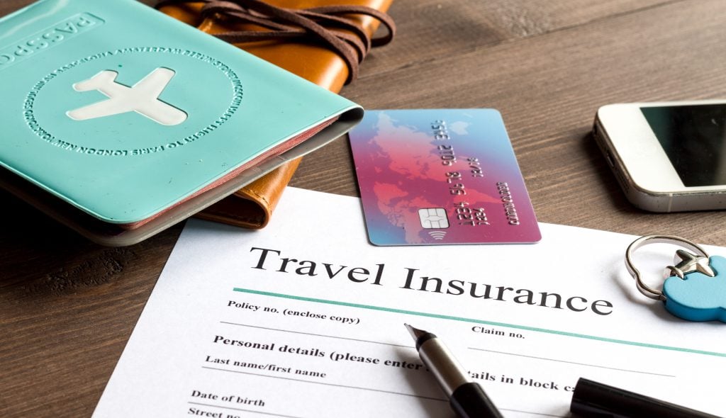 Photo of Travel Insurance Documents, Passport, and Credit Card